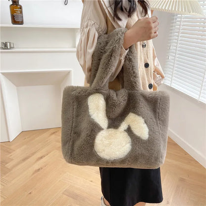 Cute cartoon rabbit ears design on a soft plush large capacity shoulder tote bag.