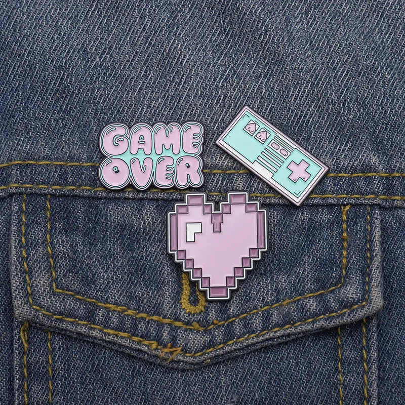 Stereo game console badge made from alloy metal in three colour options for bag mounting.