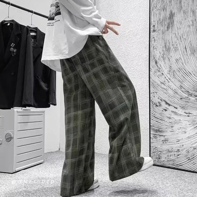 Men's black and green plaid straight leg trousers showing mid-waist design and six size options