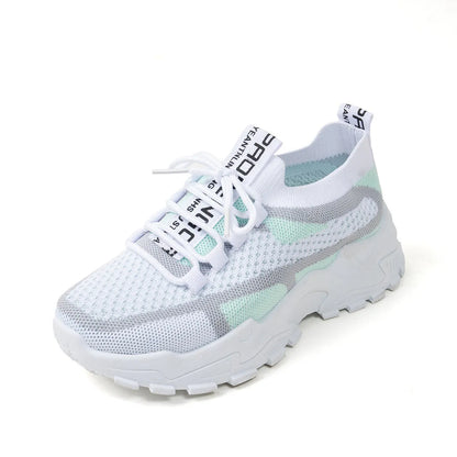 Women's Flyknit mesh lace-up sneakers in a grey colourway on a white background