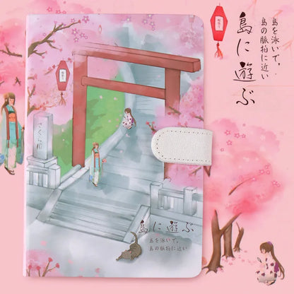 A5 wire-bound retro notebook open showing full-colour illustration of a train on its page