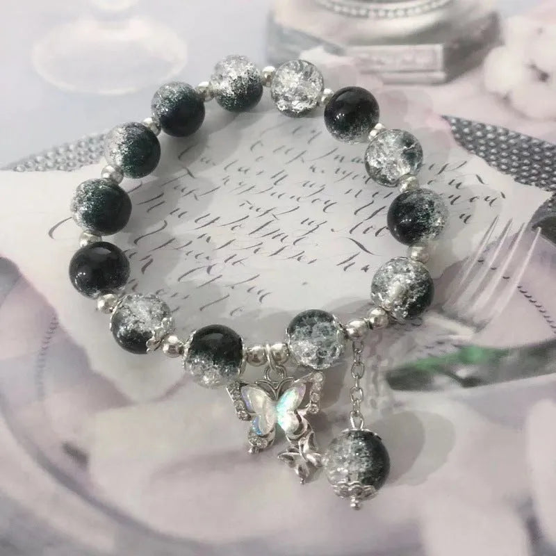 Chinese style glass bead bracelet with bamboo joint design on wrist.