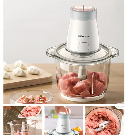 Household electric vegetable chopper blender with glass bowl and stainless steel blade on kitchen counter