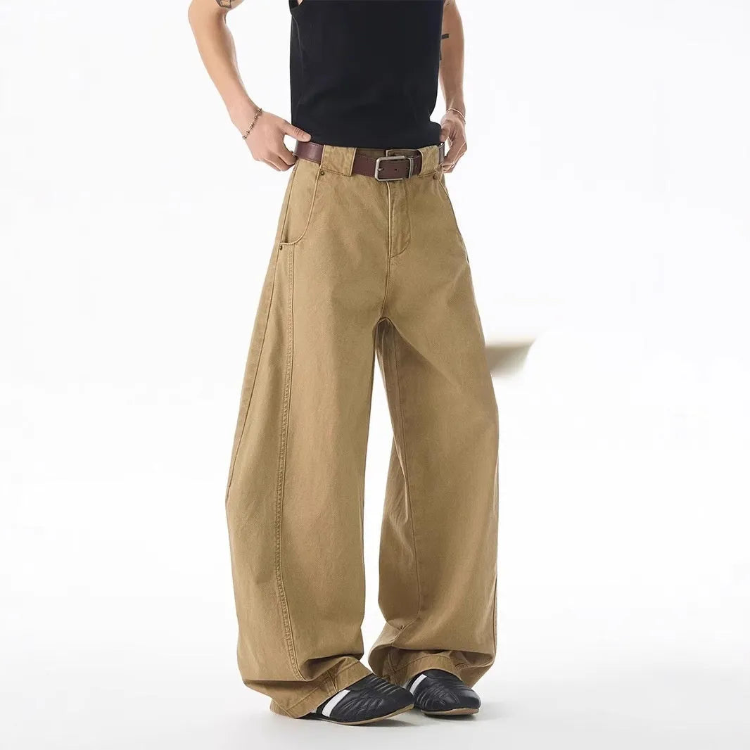Brown men's loose fit straight leg jeans with a button fly on a mid waist.