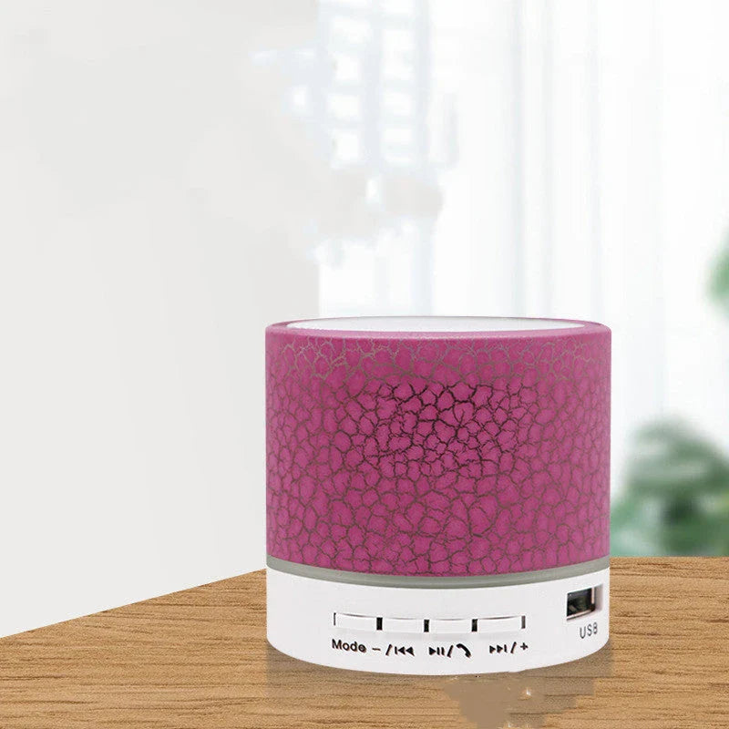 Portable Bluetooth speaker with colorful LED lights, offering impressive sound quality and convenient features for on-the-go music enjoyment.