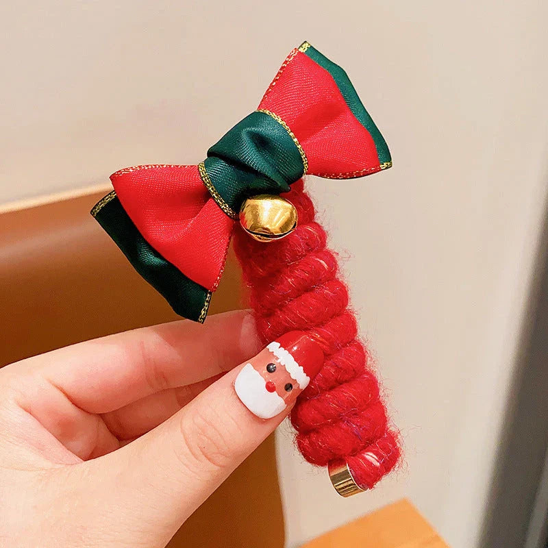 Festive Christmas hair ties with various holiday-themed designs, including red bells, green Christmas trees, and khaki deer shapes.