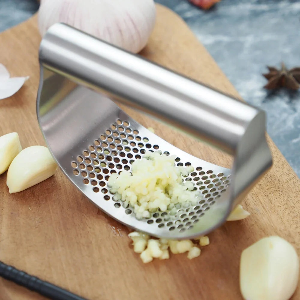 Stainless steel garlic press with uniform mincing holes measuring 10.5cm in length