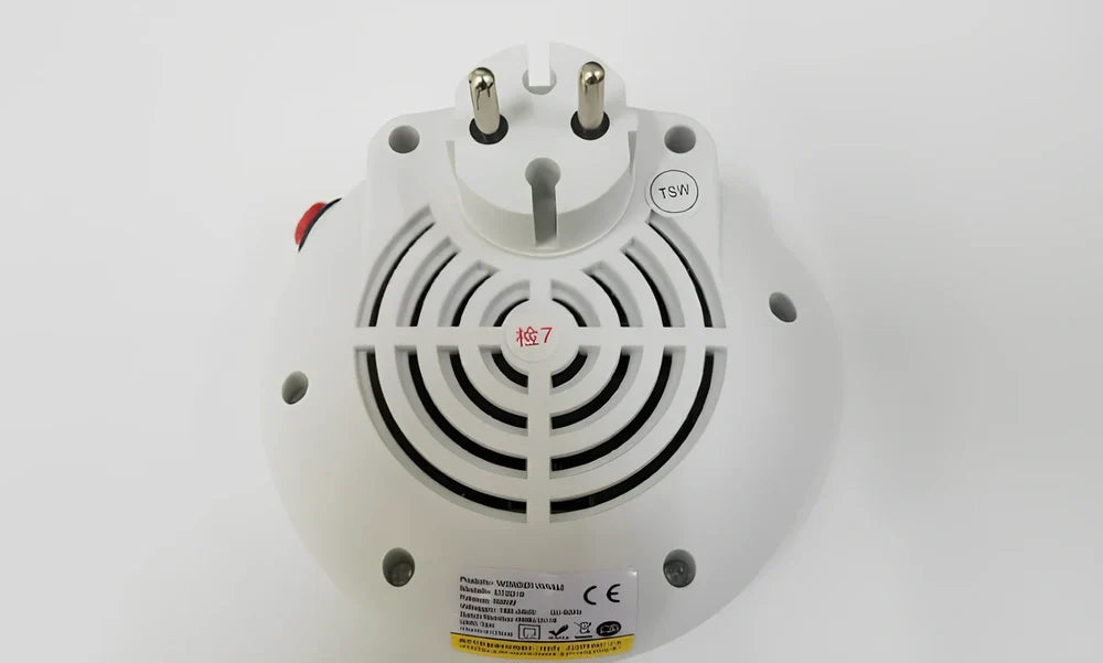 Black portable mini heater with temperature control dial showing 15-32°C range and compact design