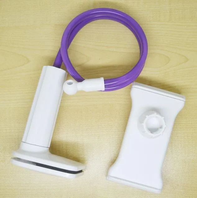 Bedside oversize flat panel handset with long arm holding a mobile phone on a table