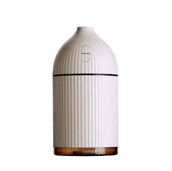 White USB-powered ultrasonic aromatherapy diffuser and humidifier with 300ml bottle and LED light on a desk.