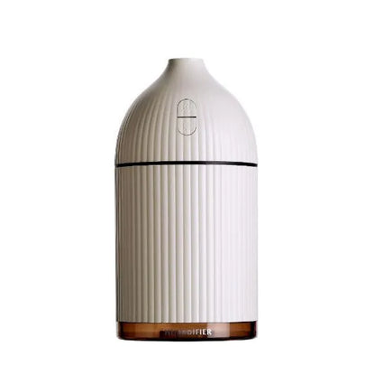 White USB-powered ultrasonic aromatherapy diffuser and humidifier with 300ml bottle and LED light on a desk.