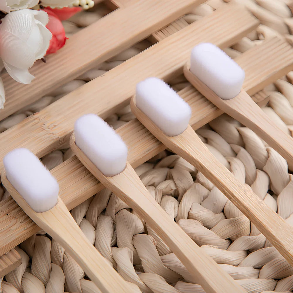 Bamboo toothbrush with wood colour handle measuring 18.5cm long with soft white bristles in protective tube