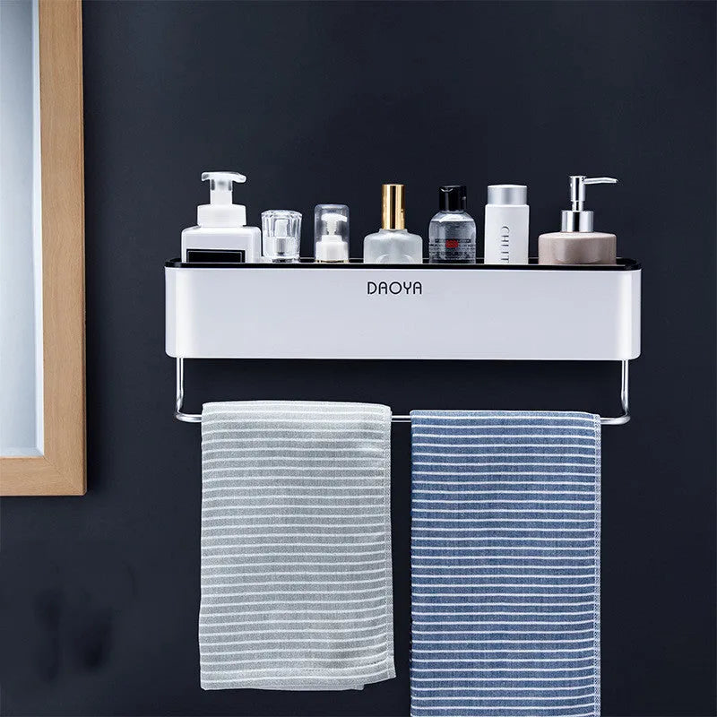 Plastic bathroom wall shelf with hole-free installation in a grey finish, holding shampoo and shower gel bottles.