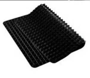 Red silicone pyramid grid cooking mat on a kitchen counter
