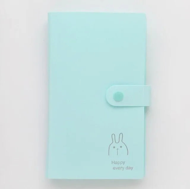 Blue PVC and PP business card holder book with a protective shell and smile logo, shown with business cards.