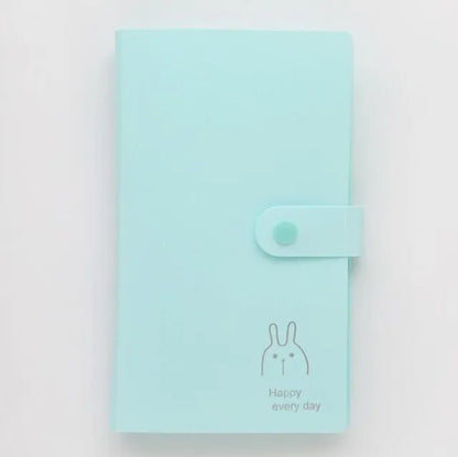 Blue PVC and PP business card holder book with a protective shell and smile logo, shown with business cards.