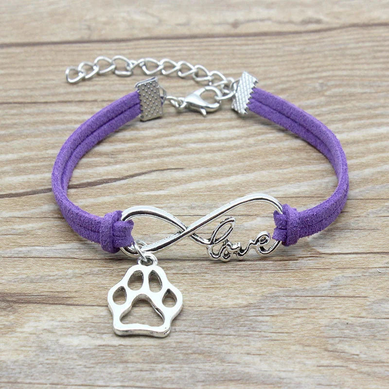 Hand-woven Infinite Love Pet Bracelet in various colors, showcasing the bow shape and alloy material.