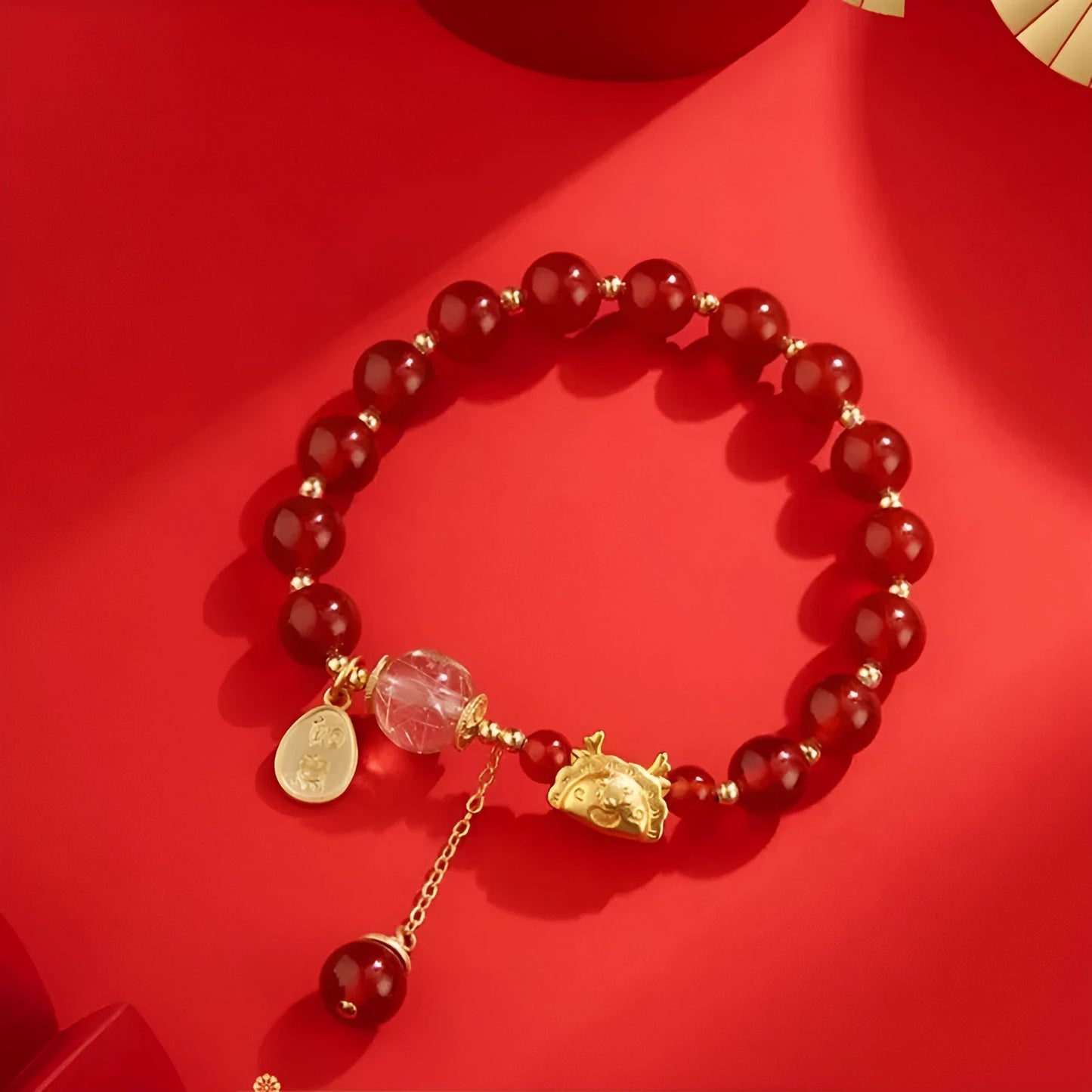 Women's Chinese style bracelet with Hetian jade, red agate beads, and a dragon design on gold and silver.