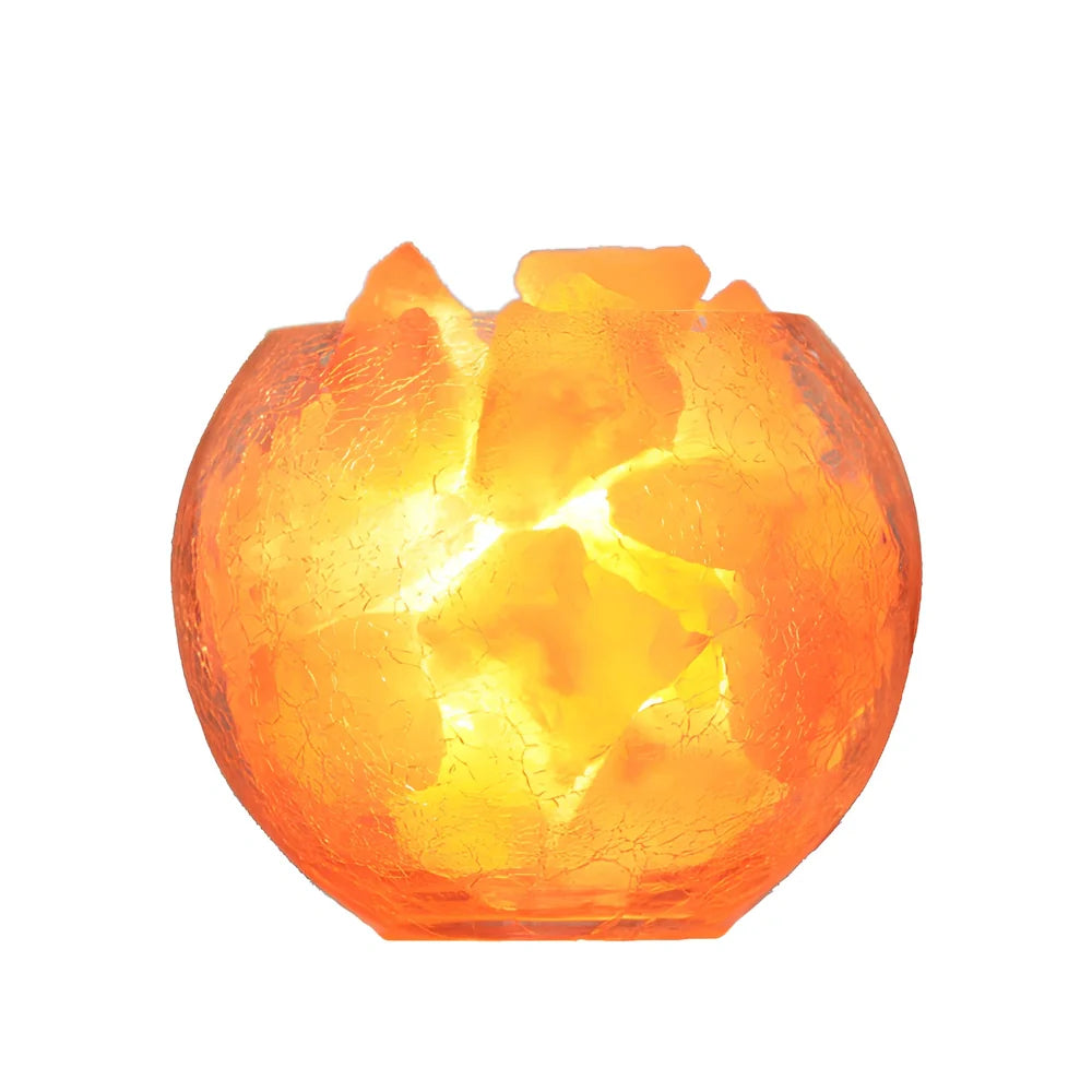 Crystal salt bedside lamp with glass shade and USB cable on wooden table