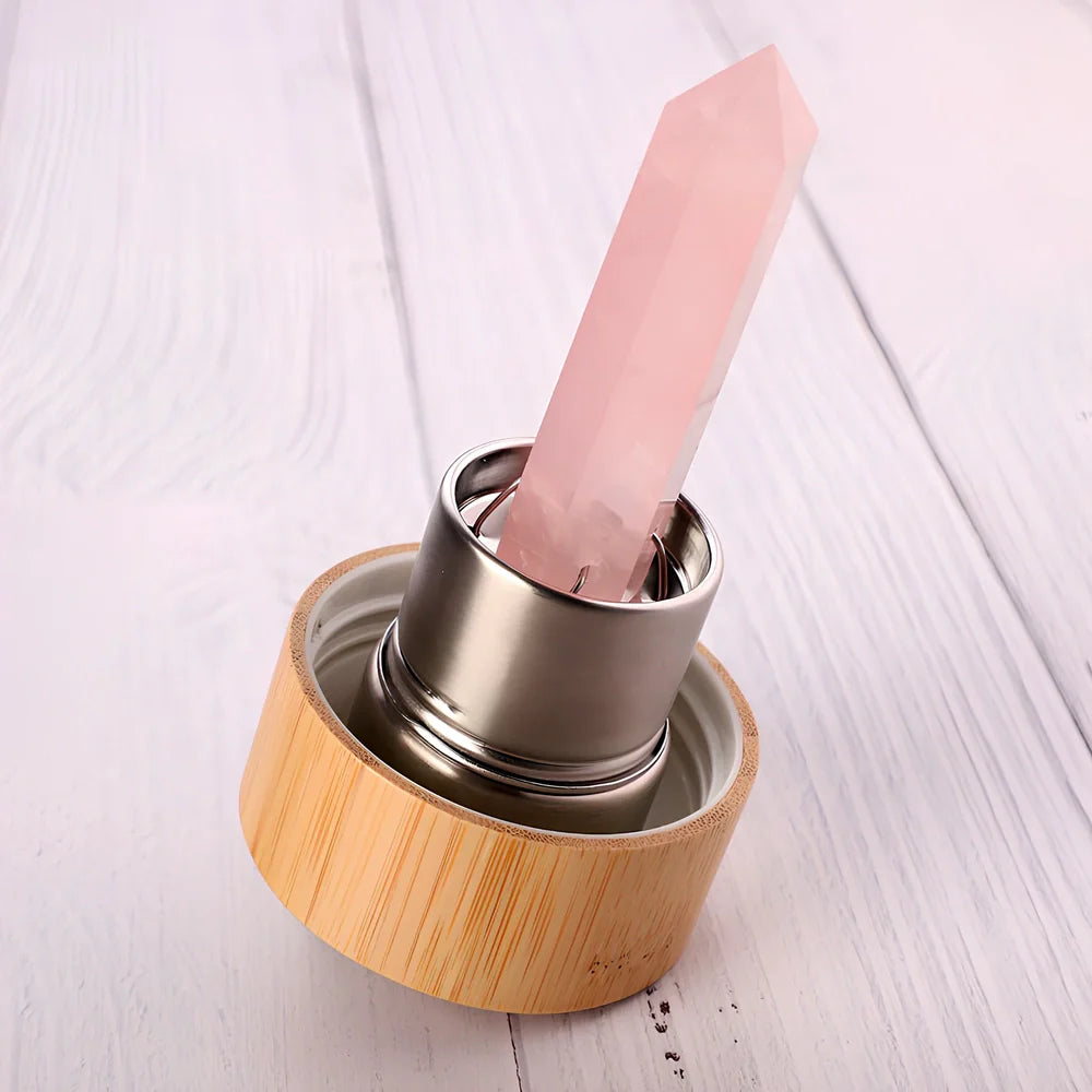 Crystal infused glass water bottle with bamboo lid showing mineral crystal inside 25cm tall container