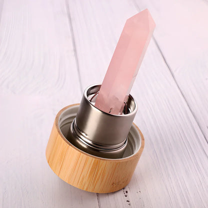 Crystal infused glass water bottle with bamboo lid showing mineral crystal inside 25cm tall container