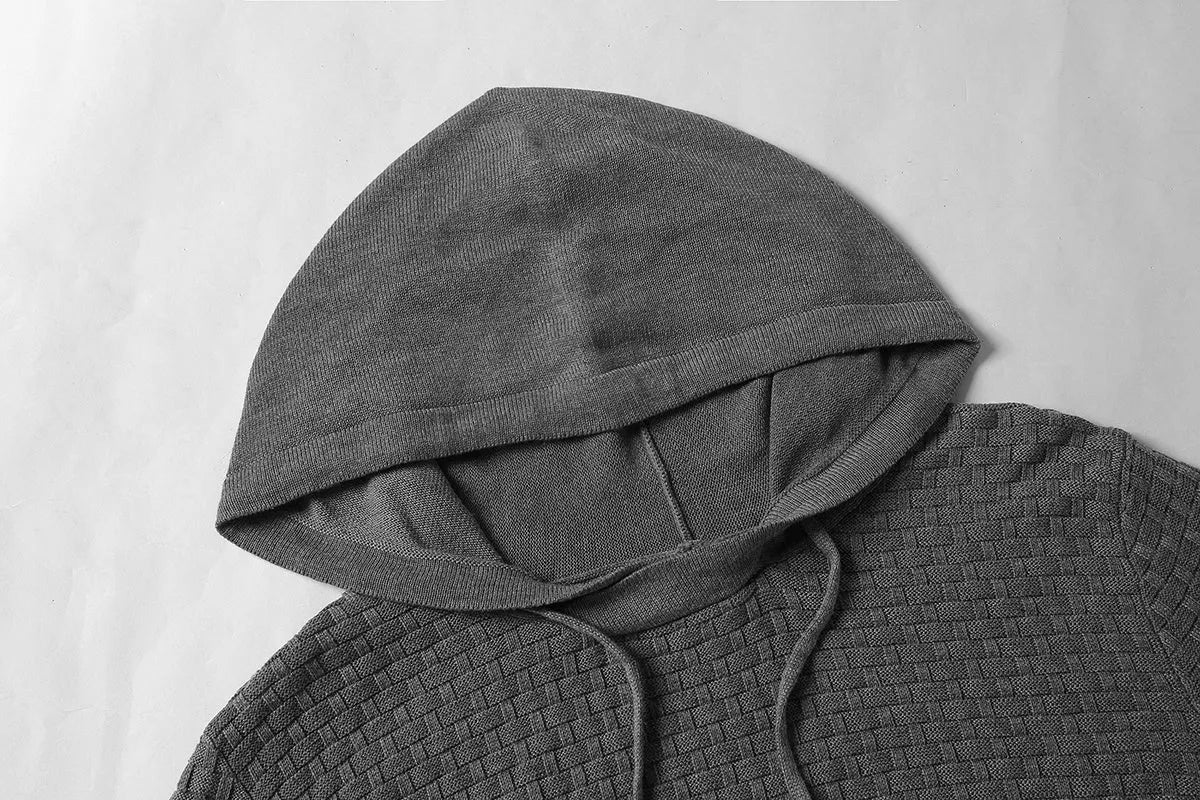 Man wearing a cotton-polyester blend hooded sweatshirt in grey, showing the front design and hood.