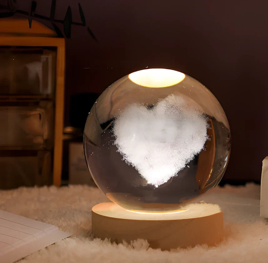 3D crystal ball night light projecting solar system pattern on wooden base with astronaut figurine