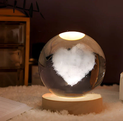 3D crystal ball night light projecting solar system pattern on wooden base with astronaut figurine