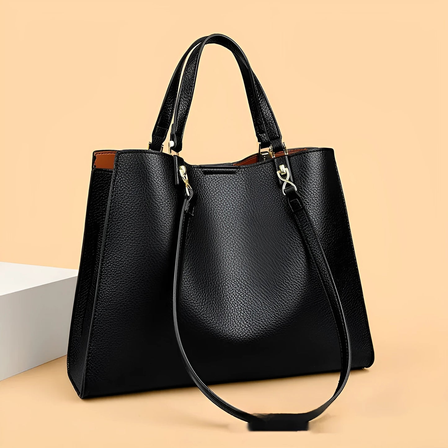 Women's horizontal square messenger tote bag in PU leather with crossbody strap and internal compartments.