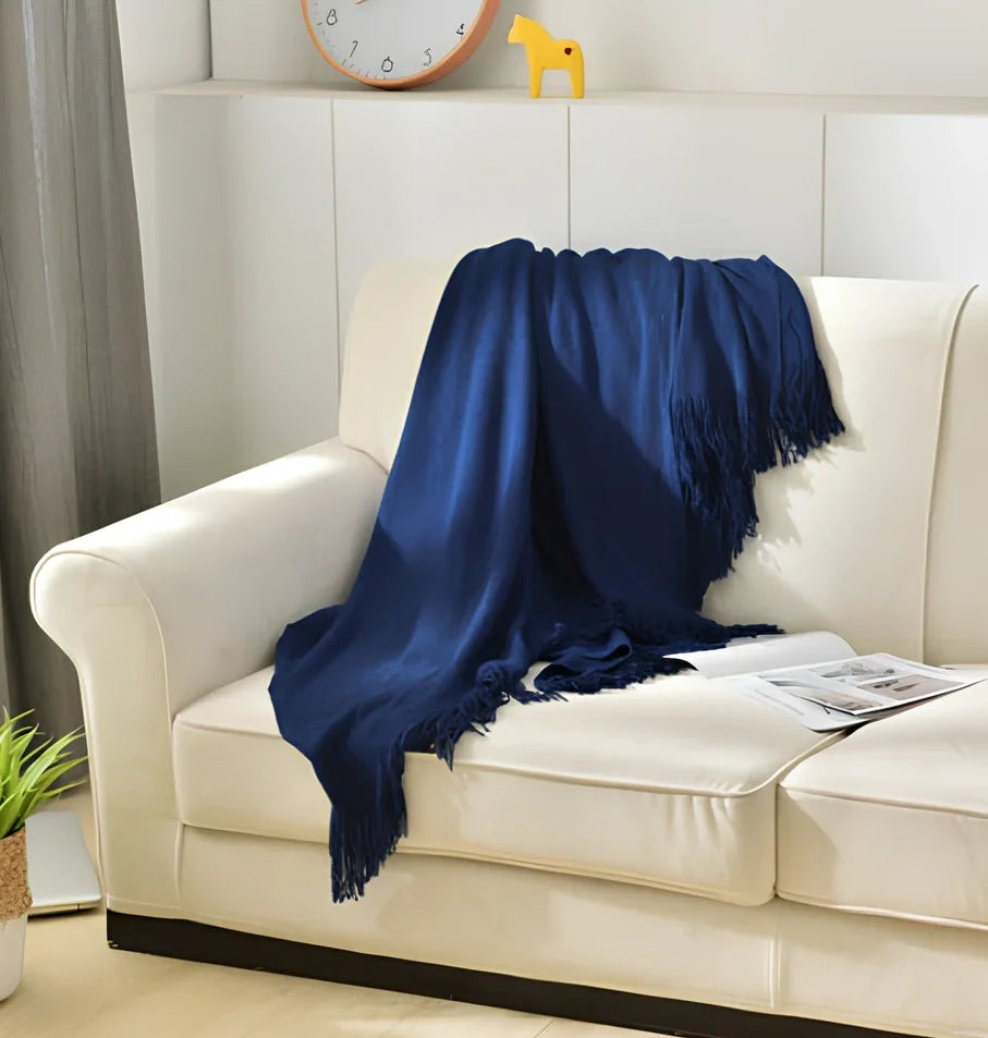 130x150cm knitted acrylic blanket with 10cm fringe detailing in beige colour draped over sofa