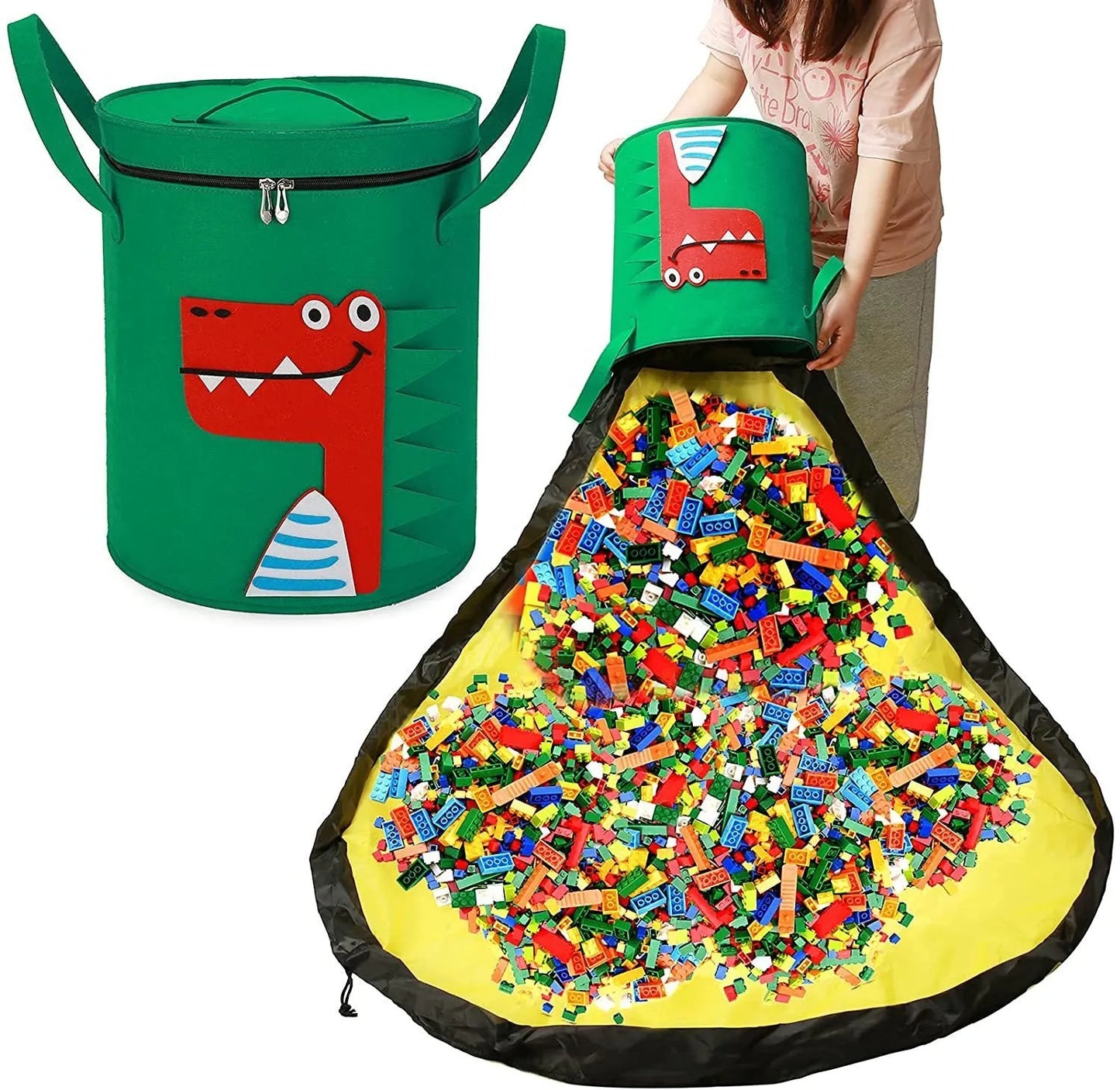 Green felt storage cube with pull rope unfolded into a large square play mat on a wooden floor.