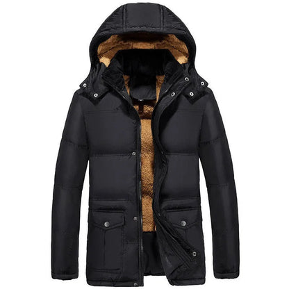 Man wearing a black velvet double-breasted padded winter jacket with a hood.