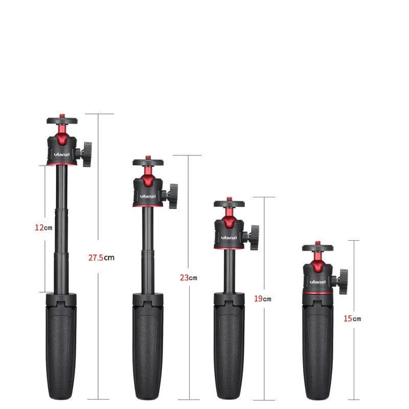Compact black red and white phone tripod selfie stick stand extended next to a mobile phone.