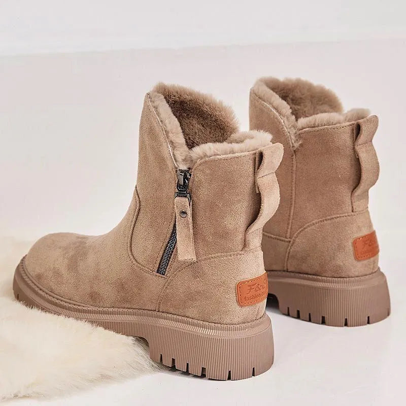 Women's black high top snow boots with a faux suede upper and side zipper on a white background.