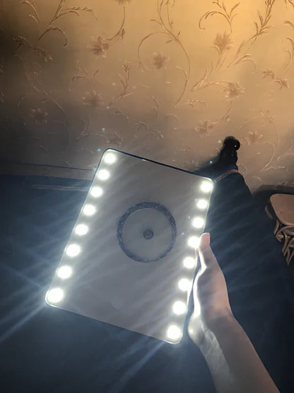 Black LED makeup mirror with 16 lights around 225mm × 165mm frame on dressing table