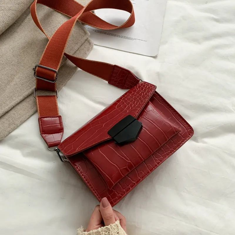 Vintage crossbody bag in black showing 20cm width, crossbody strap, and front storage compartment