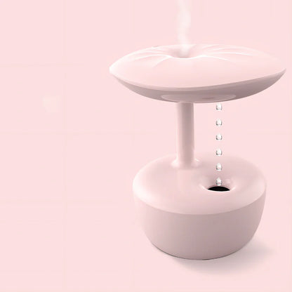 White lotus leaf shaped USB humidifier with mist output and LED illumination on wooden surface