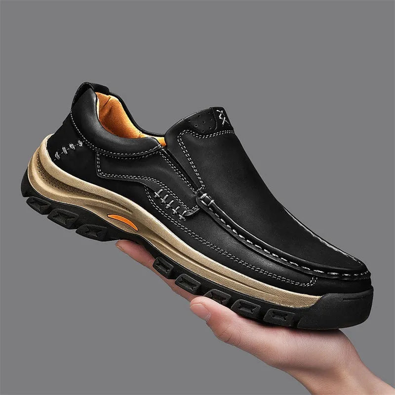 Men's black leather mountaineering shoes with thick rubber sole and round toe.