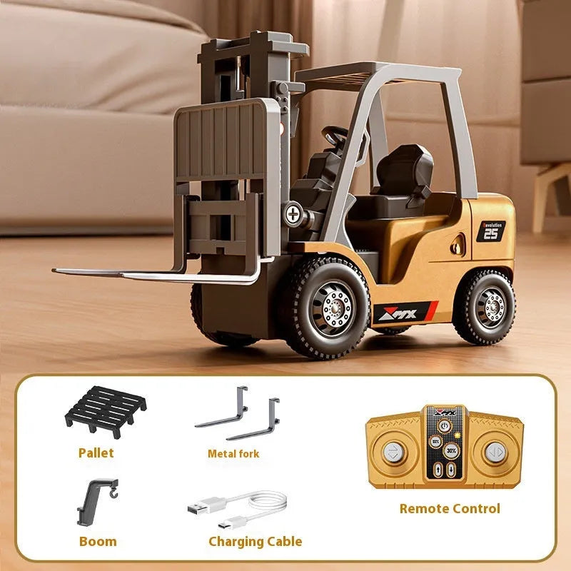 Miniature grey alloy remote control forklift toy with cargo forks and a pallet on a table.