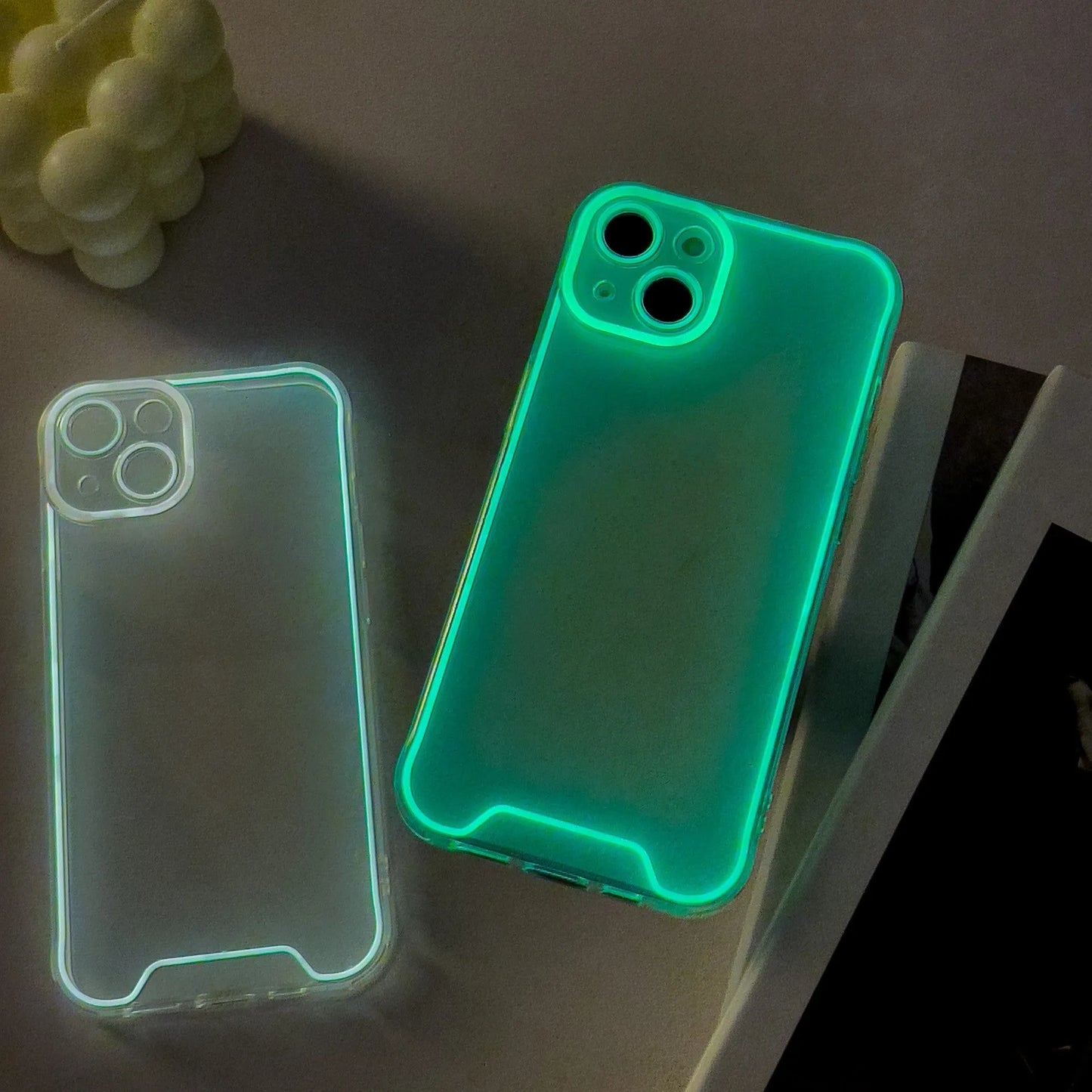 Glow-in-the-dark soft TPU iPhone case in green, orange, blue, yellow, or pink on an iPhone