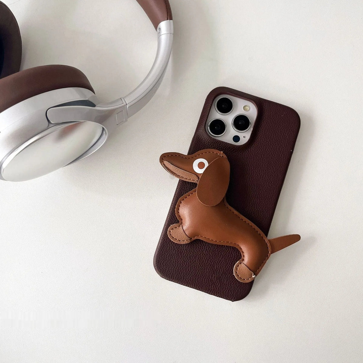 Leather sausage dog iPhone case with embossed 3D dachshund design in brown, all-inclusive anti-fall cover