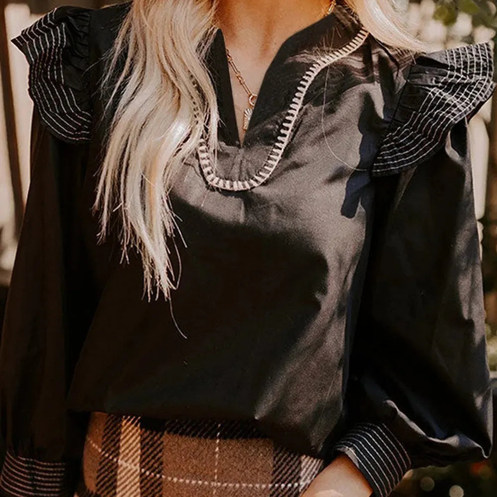 Black women's V-neck blouse with contrast stitching on neckline and long sleeves, ruffle detail