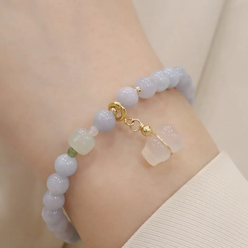 Gold plated women's bracelet with artificial crystal aquamarine chalcedony pendant in climbing cat design