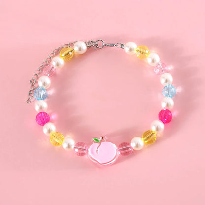 Colourful plastic bead cat necklace with adjustable clasp showing peach, rainbow, and small flower pattern options