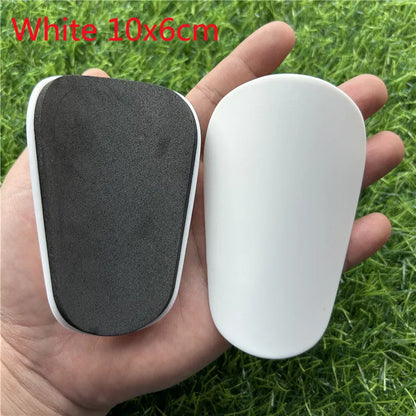 Extra small plastic football shin guards in black and white colours for youth players