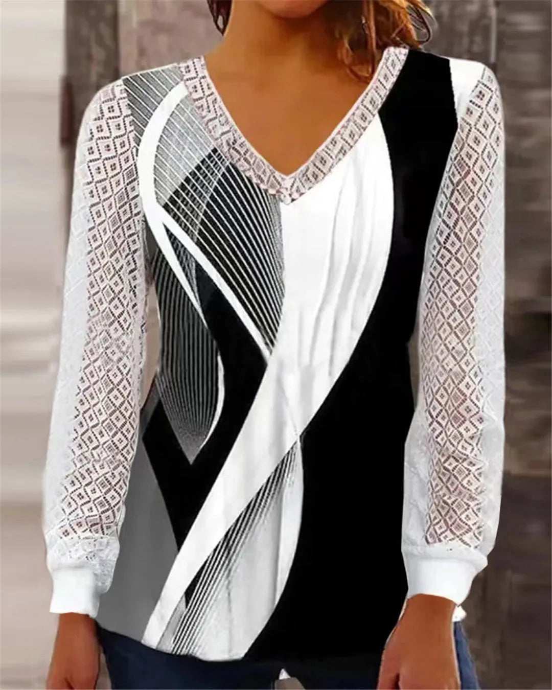 Purple V-neck loose top with hollow-out lace print and long sleeves.