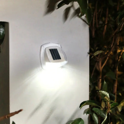 Solar garden wall lamp with waterproof housing mounted on brick wall