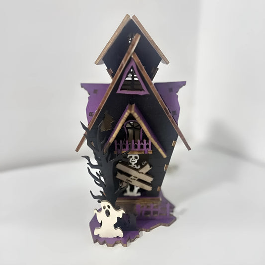 Wooden haunted house table decoration measuring 14x10.5x19cm with luminous finish and candlestick holder function
