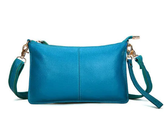 Lady's cowhide slant bag in apricot colour showing front view with strap and compact 24 cm size.