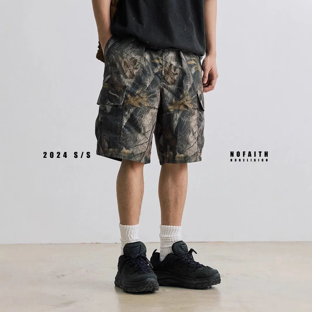 Loose straight-leg denim shorts for teenagers in army green, showing elastic waistband and zip fly.